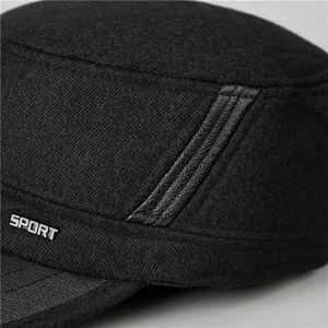 Close-up of wool fabric texture and metal SPORT tag on a black flat top military cap