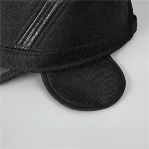Men's black flat top winter hat with ear flaps and leather stripe details