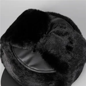 Close-up of black faux fur and leather trapper hat showing premium texture and stitching
