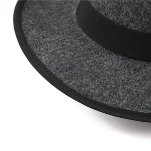 Detail of dark grey wool felt fedora featuring black ribbon trim and textured brim