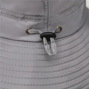 Grey outdoor sun hat with adjustable drawstring and breathable nylon fabric details
