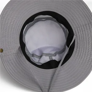 Detail of grey sun hat featuring breathable white mesh lining and adjustable chin strap