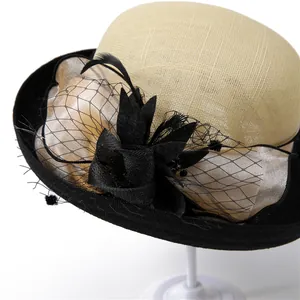 Detail of elegant linen hat with black mesh net, feathers, and floral accents
