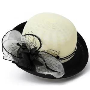 Elegant linen hat for women featuring a black mesh veil, fabric flower, and feather accents