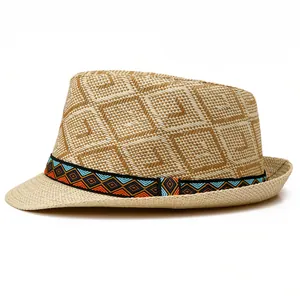 Close-up of diamond-patterned straw weave and bohemian embroidered ribbon on a fedora