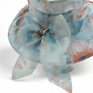 Detail of floral wide-brim sun hat with breathable mesh and decorative large bow