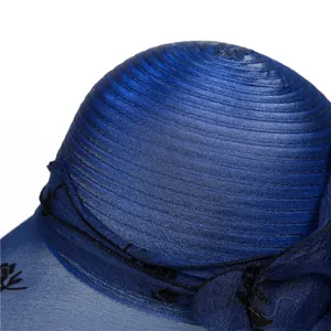 Detailed close-up of dark blue organza sun hat featuring spiral satin texture and floral lace