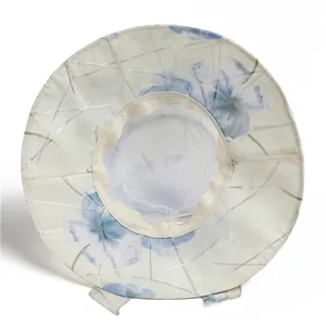 Detailed view of breathable mesh lining and floral pattern on wide brim sun hat