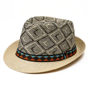 Mens woven straw fedora hat featuring black and white geometric patterns and ethnic ribbon