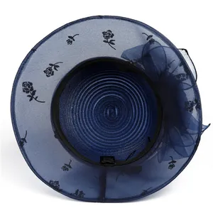 Top view of navy blue organza sun hat with rose pattern and large floral decoration
