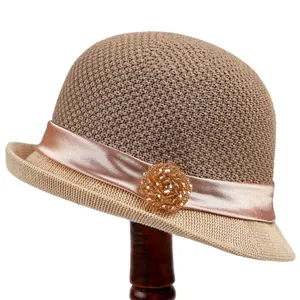 Elegant vintage khaki woven cloche sun hat with champagne ribbon and crystal brooch detail