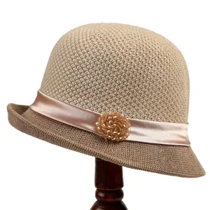 Elegant beige woven sun hat for women featuring a champagne satin ribbon and bead accent