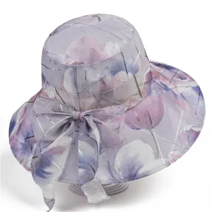 Women's wide brim sun hat with purple floral pattern and bow for UV protection