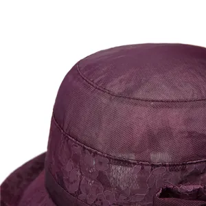 Detail of elegant purple sun hat featuring layered mesh fabric and floral lace embroidery