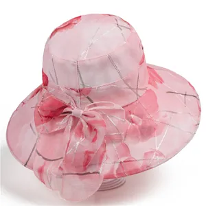 Detail of pink organza sun hat with red floral patterns and an elegant large side bow