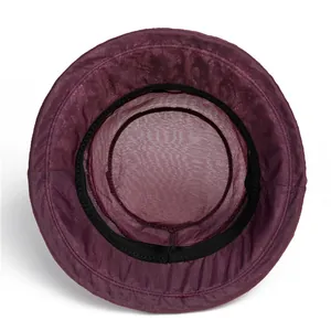 Detail view of purple sun hat featuring breathable mesh lining and black sweatband