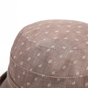 Close-up of the breathable cotton linen texture and delicate leaf pattern on the sun hat