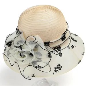 Detail of elegant beige organza sun hat featuring retro black rose floral mesh patterns
