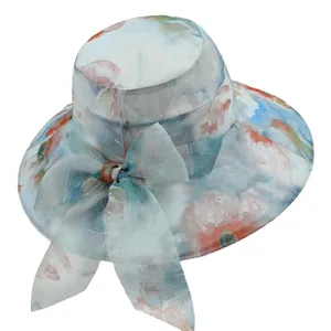 Elegant wide brim sun hat for elderly women with blue floral pattern and large bow decoration