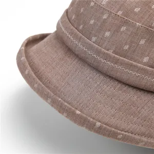 Detail of brown sun hat featuring floral embroidery and precision stitching for elderly women