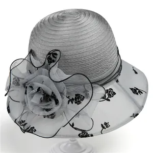 Detailed view of silver organza sun hat with black rose pattern and large mesh flower