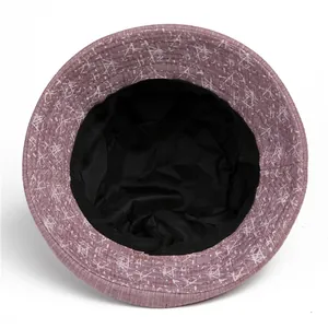 Detailed top view of purple fisherman hat featuring white abstract geometric patterns
