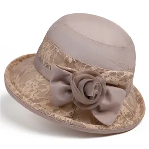 Women's pink lace sun hat with wide brim and elegant floral bow for summer UV protection