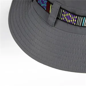 Detail of dark gray sun hat featuring bohemian woven band and reinforced stitching