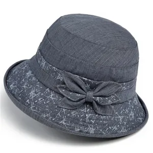 Women's dark blue bucket hat with bow detail and white geometric lines for sun protection