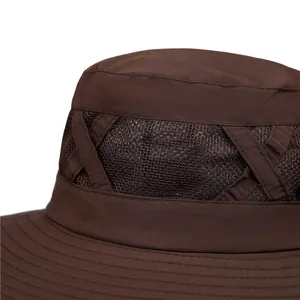 Detail of dark brown outdoor hat showing tear-resistant ripstop fabric and mesh vent
