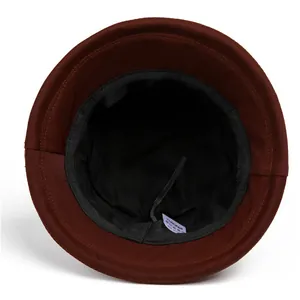 Detail view of adjustable inner strap and black lining of a dark brown sun hat