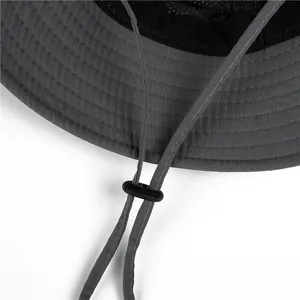 Detail of dark grey sun hat featuring mesh lining and adjustable windproof drawstring