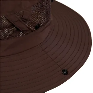 Detail of outdoor sun hat featuring breathable mesh layer and sturdy metal snap buttons