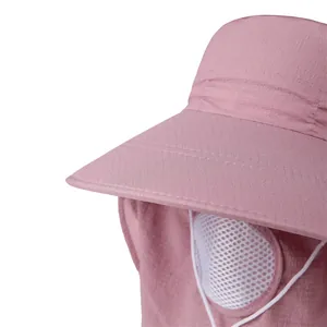Detail of pink sun hat featuring wide brim, breathable mesh mask, and quick-dry fabric texture