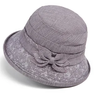 Detailed view of light purple sun hat with white geometric patterns and side bow