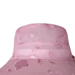 Close-up of pink sun hat featuring intricate 3D rose floral embroidery and fabric texture