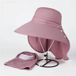 Detail view of pink sun hat with wide brim, neck protection, and breathable mesh face mask