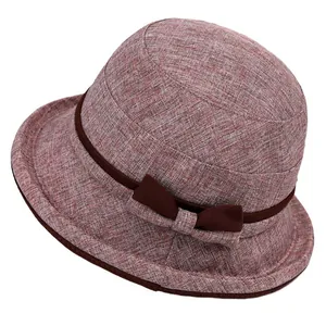 Elegant dusty pink linen cloche hat for elderly women with brown ribbon bow detail