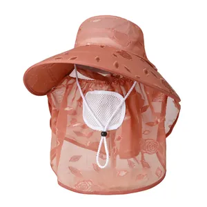 Detail of sun hat showing peach mesh fabric with delicate rose embroidery and face shield