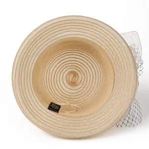 Detail of light beige organza sun hat with mesh flower and spiral weave texture