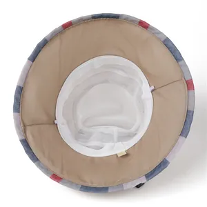 Detail of wide brim sun hat showing white mesh lining and striped edge decoration