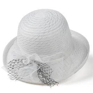 Detail of elegant white organza sun hat with mesh flower and black diamond patterns