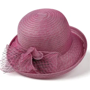 Detail of rose red organza fascinator hat with elegant mesh flower and weave texture