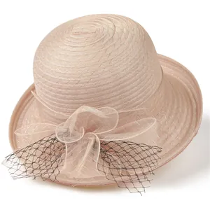 Detailed close-up of elegant champagne pink organza sun hat with mesh flower and veil
