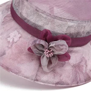 Women's summer wide brim sun hat with elegant mesh flower and pearl detail in purple