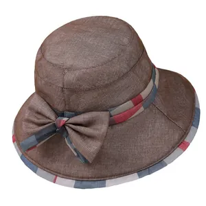 Elegant women's brown sun hat with wide brim and plaid bow detail for summer travel