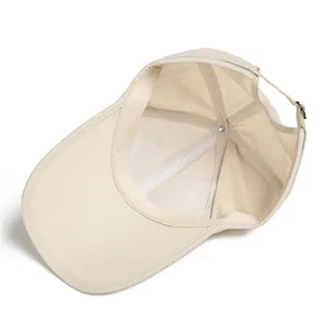 Detail of breathable mesh lining and laser-cut vents on a beige lightweight sun baseball cap