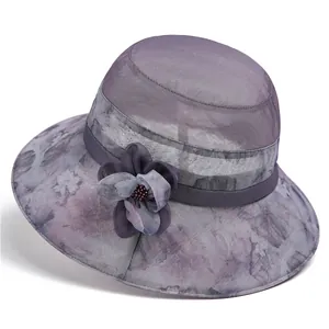 Close-up of purple mesh sun hat with floral print and 3D floral accent for elderly women