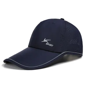 Detail view of navy blue quick-dry cap with laser-cut holes and reflective safety strips