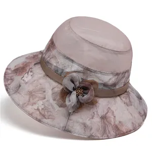Detail of mesh sun hat with floral brim and 3D flower accent for mature women
